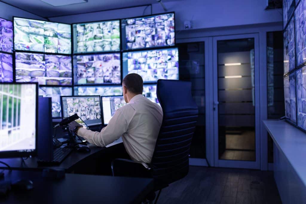 man with many screens in charge of security